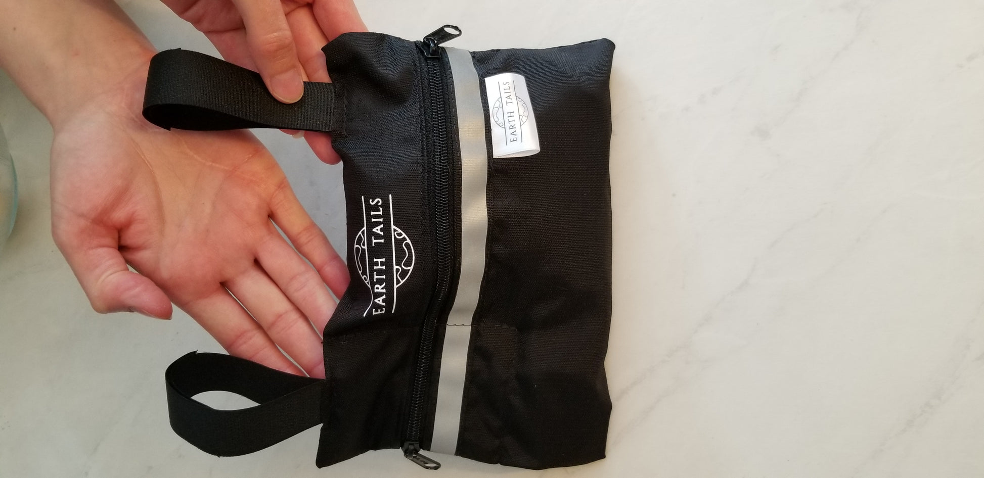 The Lil' Roller bag zipped up with a dog waste bag filled with 4 medium-sized banana peels to illustrate the amount of dog waste which can be held in this bag. 